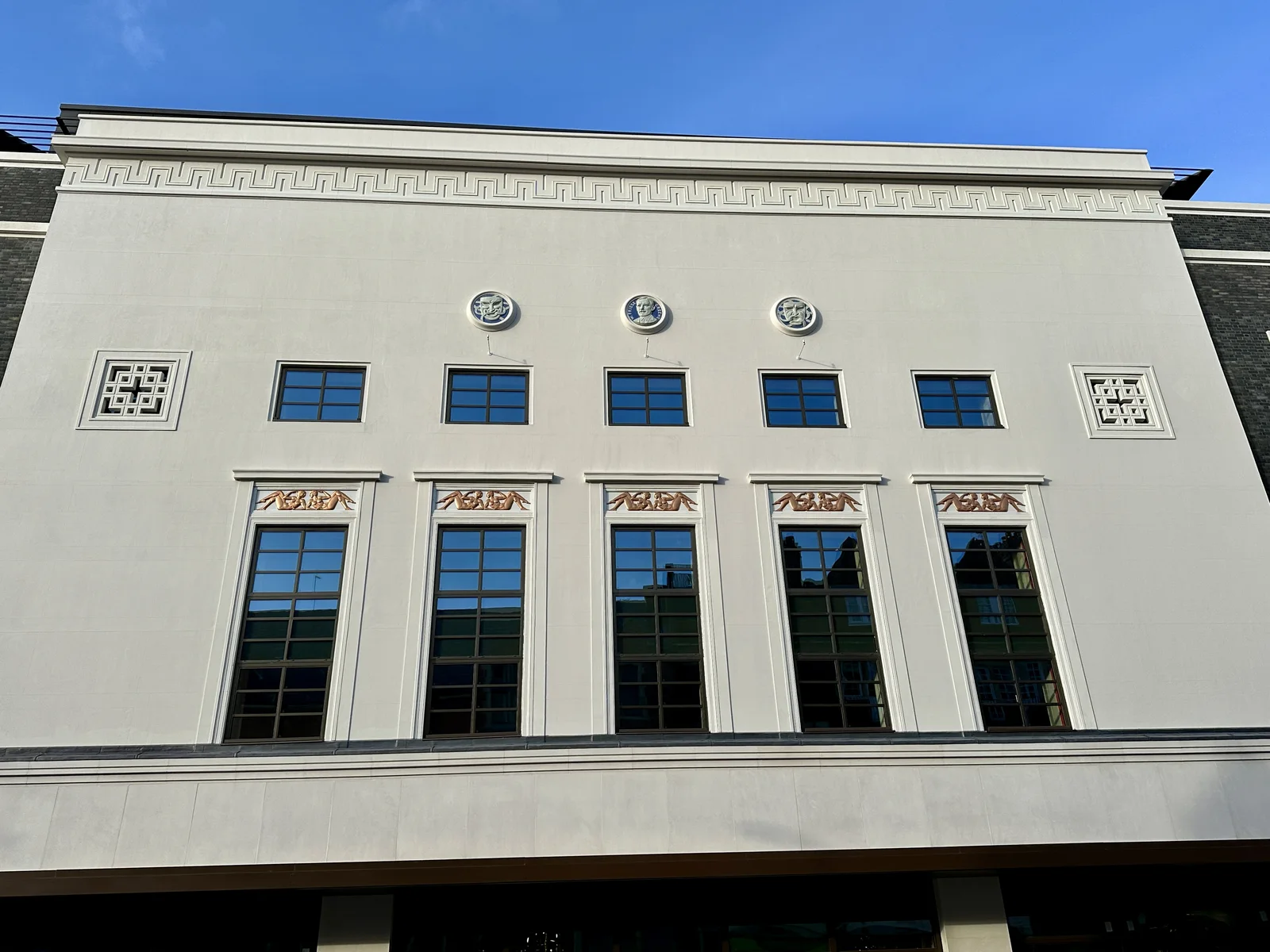 Art Deco Cinema Facade: A stepped cinema frontage with geometric ornament, signage, and a prominent entrance.