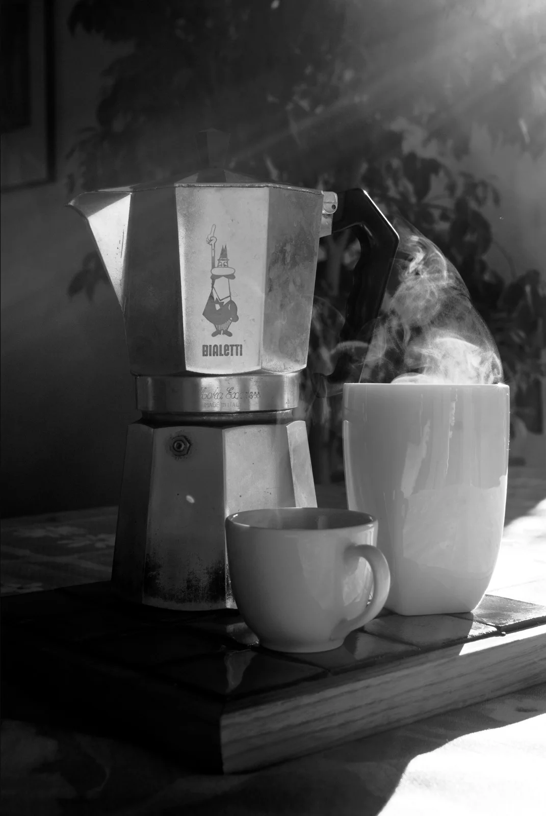 Bialetti Moka Express: An octagonal stovetop coffee maker with stacked chambers, a dark handle, and a faceted metal body.