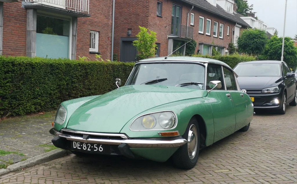 Citroën DS: A long aerodynamic car with a low nose, tapered rear, thin roof supports, and smooth surfaces.