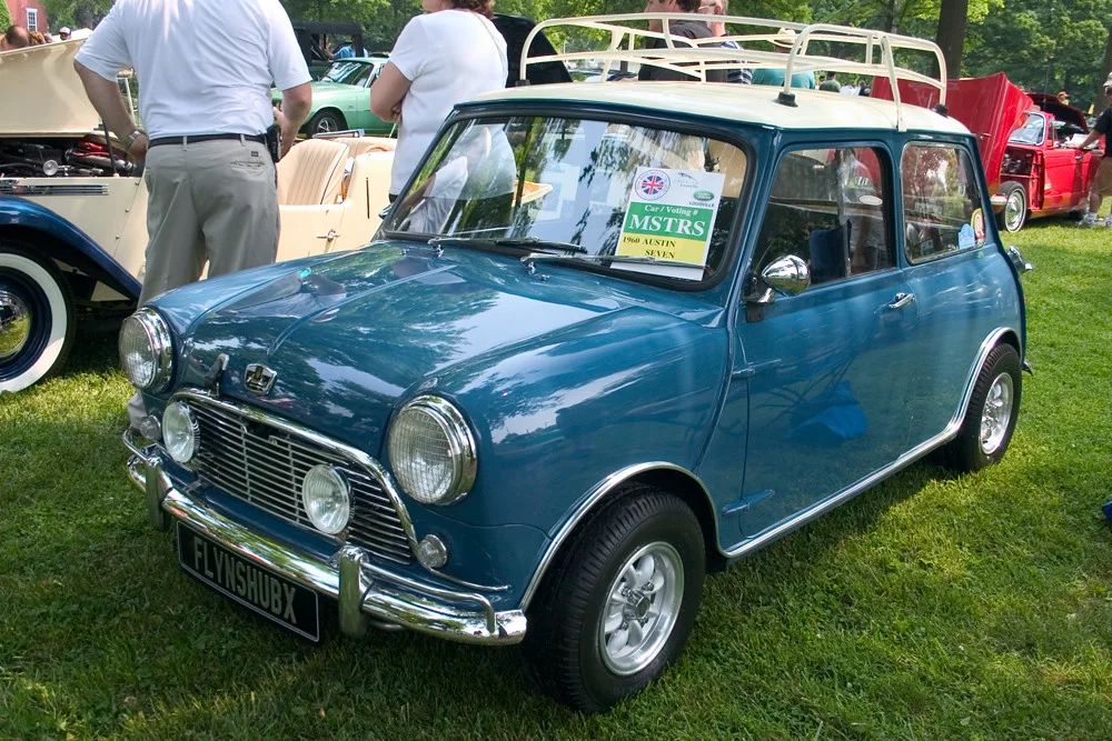 Classic Mini: A compact car with a short bonnet, upright cabin, small wheels, and rounded details.