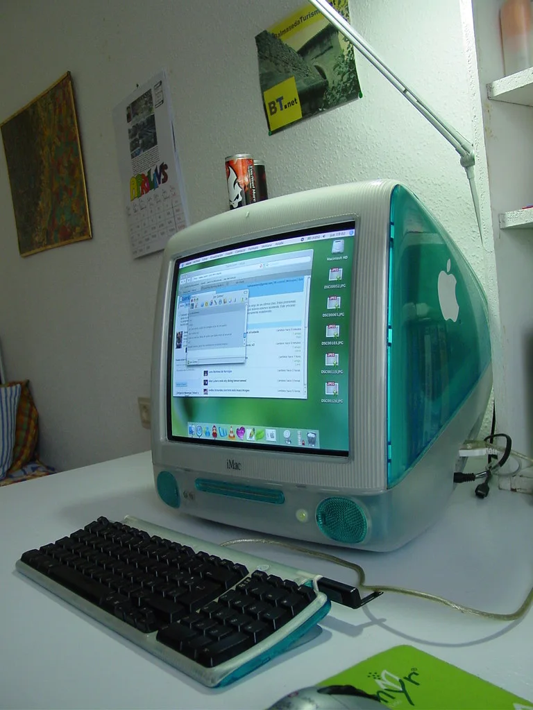 Original iMac G3: A rounded translucent computer case with a visible handle, compact footprint, and bright colour.
