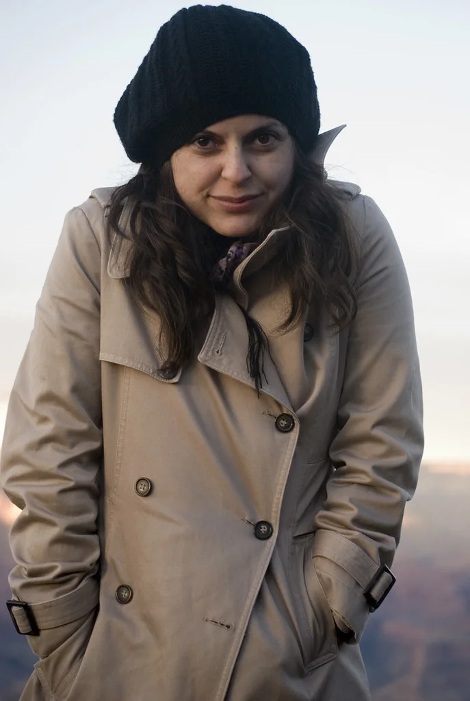 Trench Coat: A belted double-breasted coat with a storm flap, shoulder details, and a straight fall.